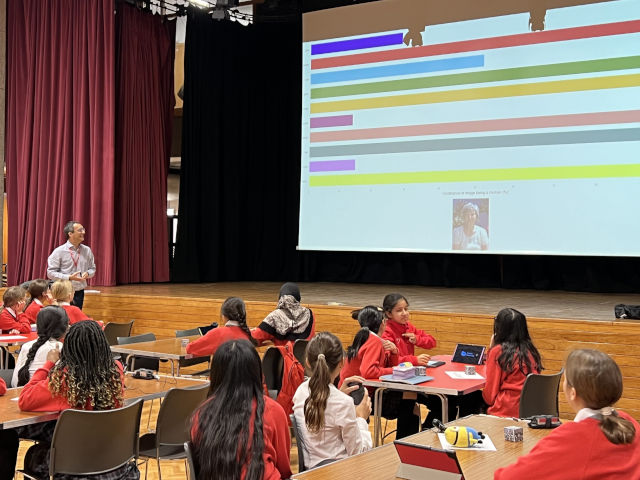 Workshop taking place in a school hall with female pupils